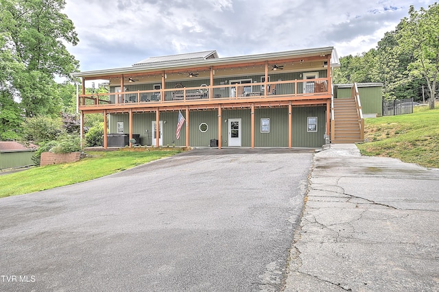 476 Sportsman Dock Rd, Piney Flats, TN 37686 - view of front facade featuring a ceiling fan, a wooden deck, stairway, asphalt driveway, and a front lawn