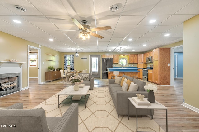 476 Sportsman Dock Rd, Piney Flats, TN 37686 - living room with light wood-style flooring, baseboards, a fireplace, a ceiling fan, and recessed lighting