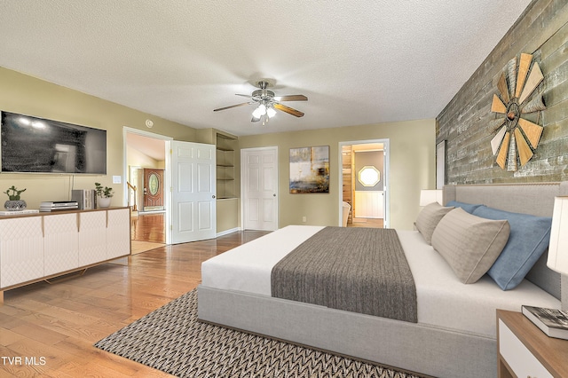 476 Sportsman Dock Rd, Piney Flats, TN 37686 - bedroom featuring wood finished floors, ensuite bathroom, a ceiling fan, and a textured ceiling