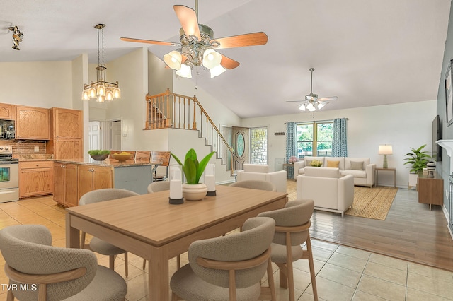 476 Sportsman Dock Rd, Piney Flats, TN 37686 - dining room featuring a ceiling fan, stairway, light tile patterned floors, and high vaulted ceiling