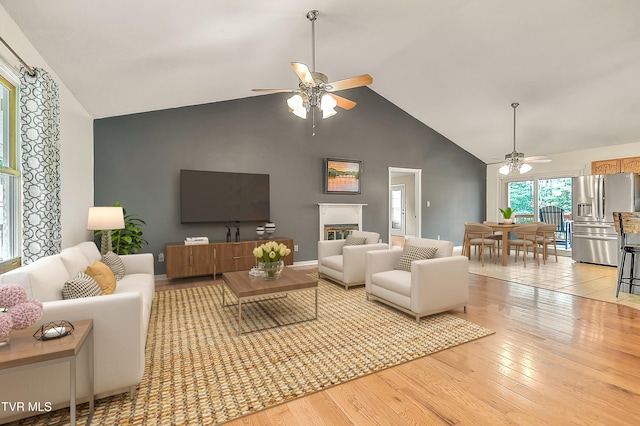 476 Sportsman Dock Rd, Piney Flats, TN 37686 - living room with ceiling fan, high vaulted ceiling, and light wood finished floors