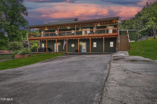 476 Sportsman Dock Rd, Piney Flats, TN 37686 - view of front of house featuring a deck, stairs, driveway, and a front lawn