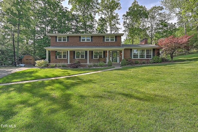 2309 Oxford Ct, Kingsport, TN 37660 - traditional home with brick siding, covered porch, driveway, and a front yard