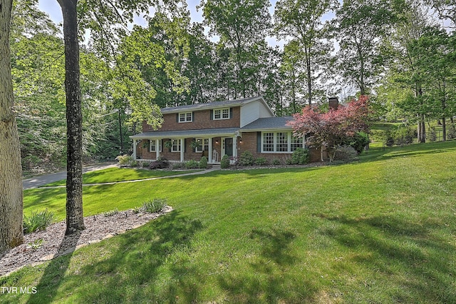 2309 Oxford Ct, Kingsport, TN 37660 - traditional-style house featuring brick siding, a chimney, a front lawn, and covered porch