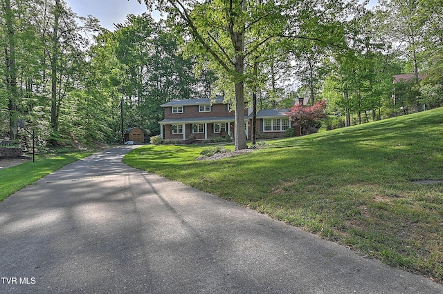 2309 Oxford Ct, Kingsport, TN 37660 - view of front of property with a front yard, an outbuilding, a chimney, and asphalt driveway