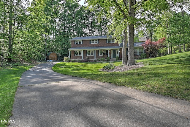 2309 Oxford Ct, Kingsport, TN 37660 - view of front of home with an outbuilding, driveway, a front lawn, and brick siding