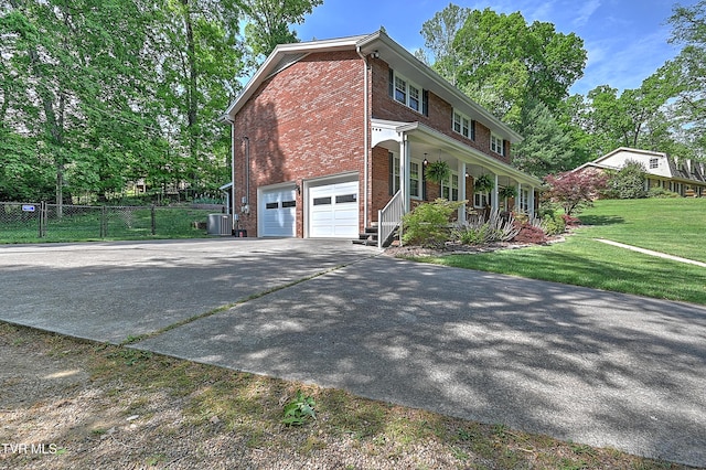 2309 Oxford Ct, Kingsport, TN 37660 - view of home's exterior featuring brick siding, covered porch, an attached garage, concrete driveway, and central air condition unit