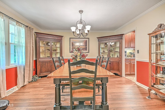 2309 Oxford Ct, Kingsport, TN 37660 - dining space featuring a chandelier, light wood-style flooring, and ornamental molding