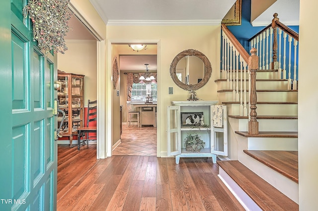 2309 Oxford Ct, Kingsport, TN 37660 - entrance foyer with wood finished floors, stairs, crown molding, a chandelier, and baseboards