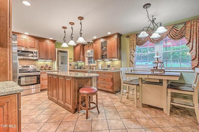 2309 Oxford Ct, Kingsport, TN 37660 - kitchen featuring appliances with stainless steel finishes, a chandelier, recessed lighting, a center island, and tasteful backsplash