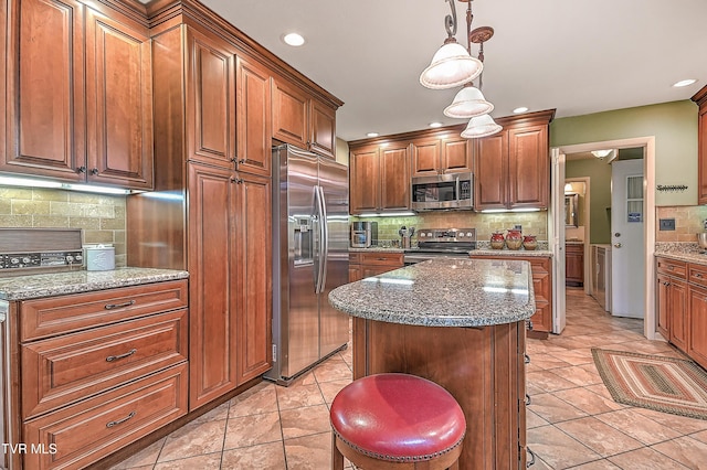 2309 Oxford Ct, Kingsport, TN 37660 - kitchen with stainless steel appliances, decorative backsplash, light tile patterned flooring, recessed lighting, and a kitchen island