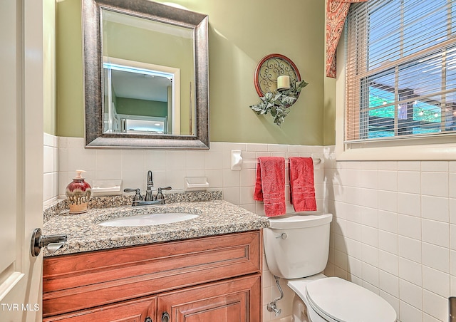 2309 Oxford Ct, Kingsport, TN 37660 - bathroom with tile walls, toilet, vanity, and a wainscoted wall