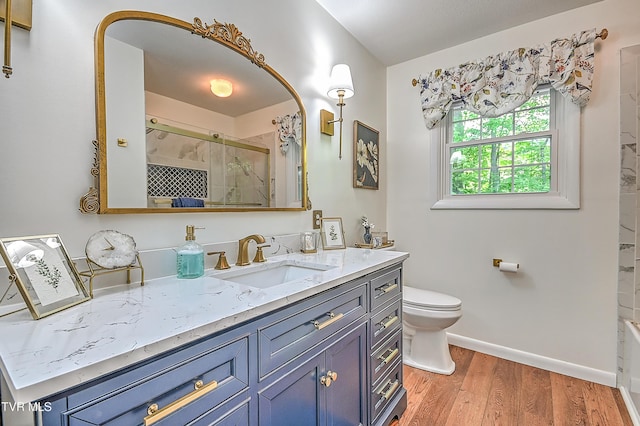 2309 Oxford Ct, Kingsport, TN 37660 - full bathroom with an enclosed shower, wood finished floors, baseboards, vanity, and toilet