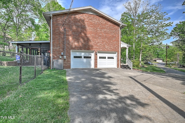 2309 Oxford Ct, Kingsport, TN 37660 - view of side of property with driveway, an attached garage, brick siding, and cooling unit