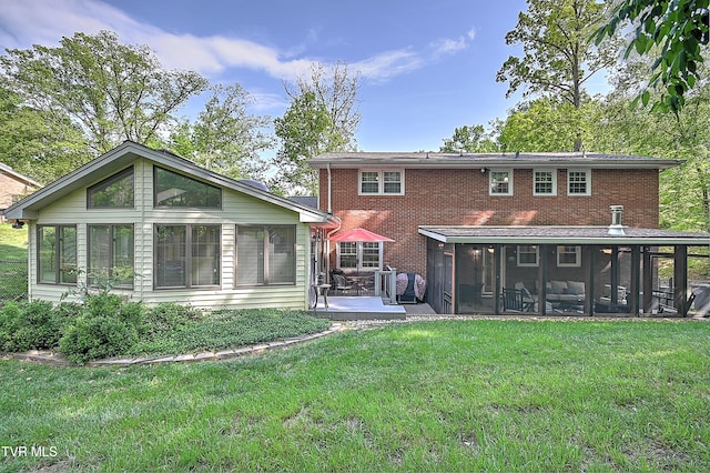 2309 Oxford Ct, Kingsport, TN 37660 - rear view of house featuring a sunroom, brick siding, a lawn, and a patio area