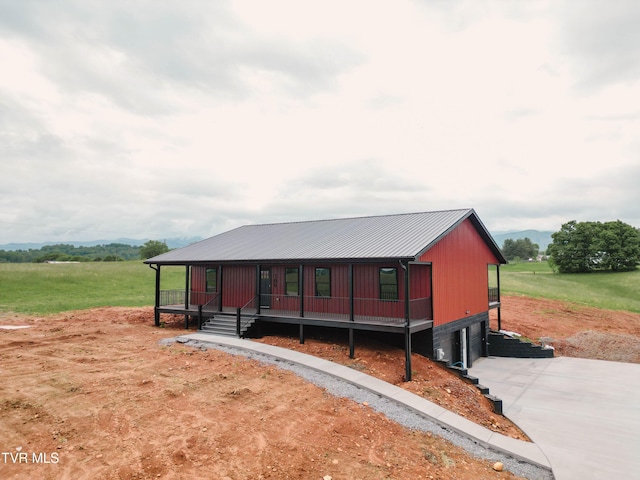 105 Ottinger Ln, Chuckey, TN 37641 - view of front of house with concrete driveway, a garage, covered porch, and metal roof