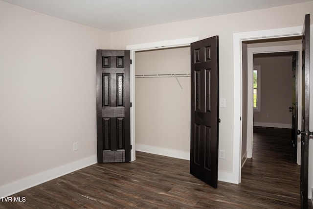 105 Ottinger Ln, Chuckey, TN 37641 - unfurnished bedroom featuring baseboards, dark wood finished floors, and a closet