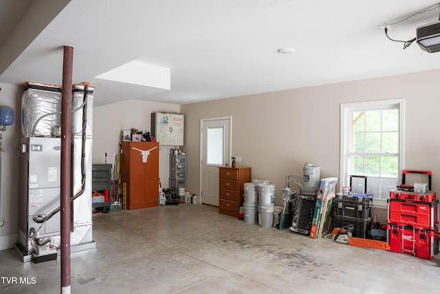 garage with a garage door opener and heating unit