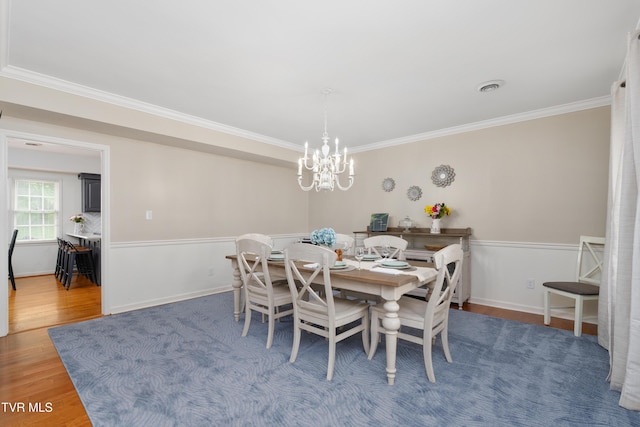 821 Regency Dr, Johnson City, TN 37604 - dining area featuring ornamental molding, a chandelier, wood finished floors, and baseboards