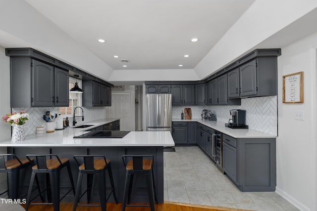 821 Regency Dr, Johnson City, TN 37604 - kitchen featuring freestanding refrigerator, a peninsula, backsplash, light countertops, and recessed lighting