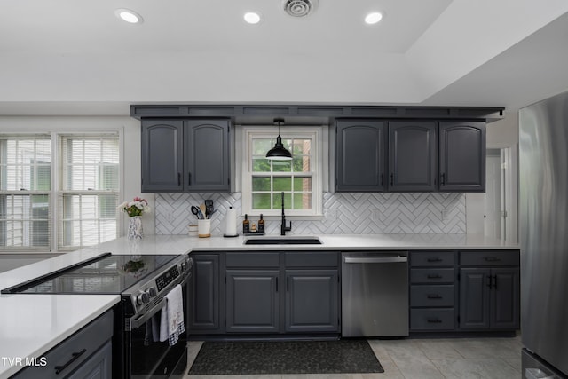 821 Regency Dr, Johnson City, TN 37604 - kitchen featuring appliances with stainless steel finishes, a sink, light countertops, backsplash, and recessed lighting