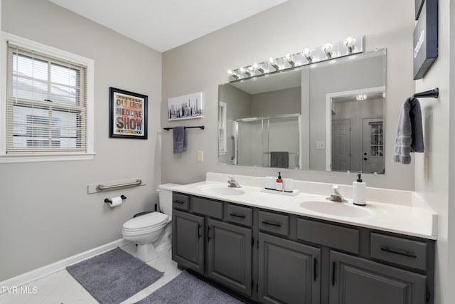 821 Regency Dr, Johnson City, TN 37604 - full bath featuring double vanity, toilet, a stall shower, baseboards, and tile patterned flooring