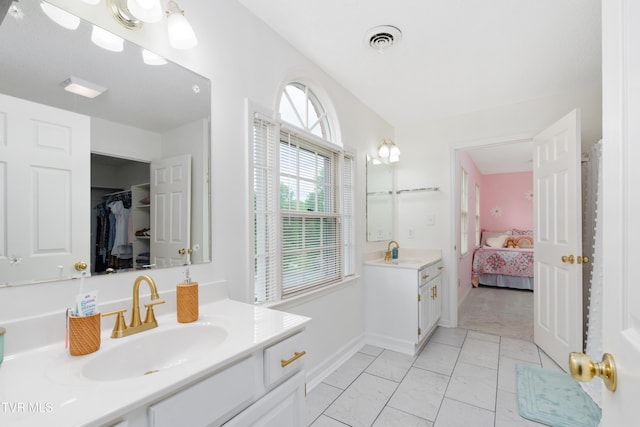 821 Regency Dr, Johnson City, TN 37604 - ensuite bathroom featuring baseboards and two vanities