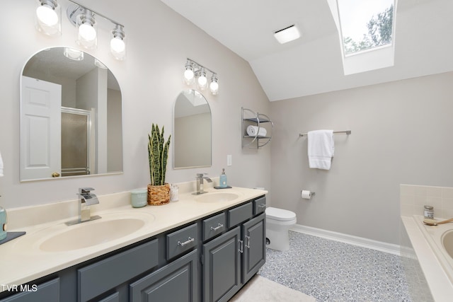 821 Regency Dr, Johnson City, TN 37604 - full bathroom with vaulted ceiling, a bath, baseboards, double vanity, and a skylight