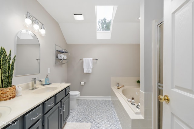 821 Regency Dr, Johnson City, TN 37604 - bathroom with a skylight, vaulted ceiling, a garden tub, double vanity, and toilet