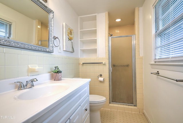 441 High Ridge Rd, Kingsport, TN 37660 - bathroom featuring a stall shower, tile walls, toilet, vanity, and a wainscoted wall