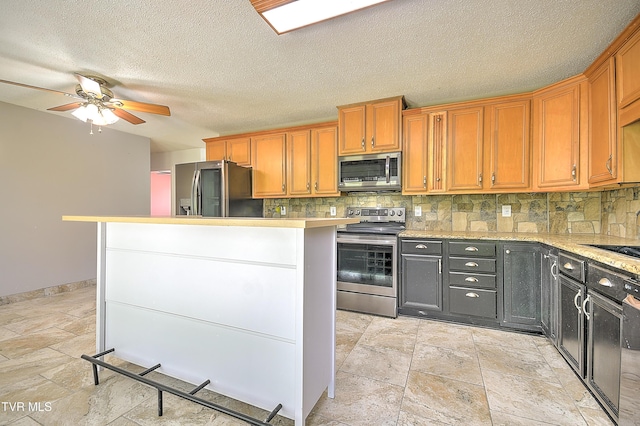 18505 Ironwood Loop, Abingdon, VA 24210 - kitchen featuring appliances with stainless steel finishes, stone tile flooring, backsplash, light countertops, and a textured ceiling