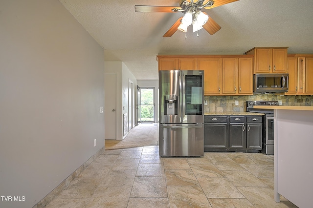 18505 Ironwood Loop, Abingdon, VA 24210 - kitchen with appliances with stainless steel finishes, a textured ceiling, decorative backsplash, light countertops, and baseboards