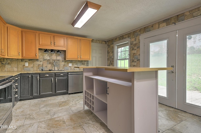 18505 Ironwood Loop, Abingdon, VA 24210 - kitchen featuring appliances with stainless steel finishes, light countertops, a sink, tasteful backsplash, and stone tile floors