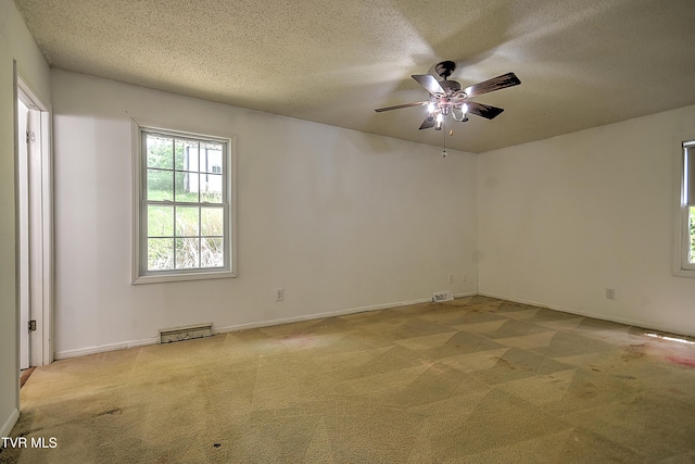 18505 Ironwood Loop, Abingdon, VA 24210 - spare room with light colored carpet, ceiling fan, a textured ceiling, and baseboards