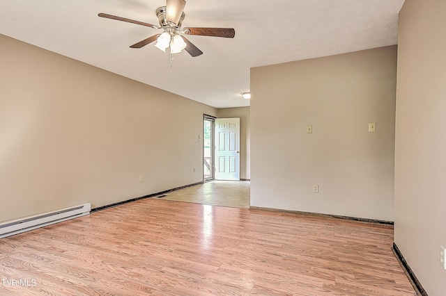 unfurnished room featuring a ceiling fan, light wood finished floors, and baseboards