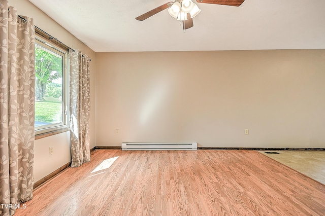 spare room featuring a baseboard radiator, ceiling fan, light wood finished floors, and baseboards