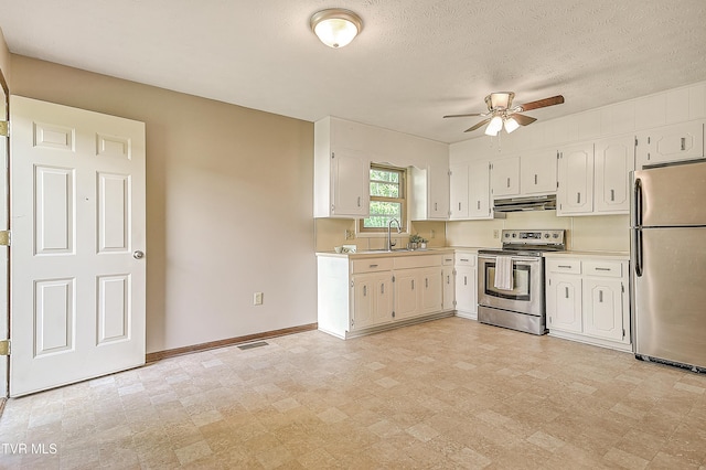 kitchen with appliances with stainless steel finishes, under cabinet range hood, a ceiling fan, light countertops, and baseboards