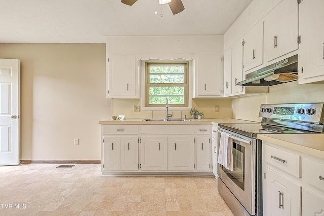 kitchen with stainless steel electric range, under cabinet range hood, a sink, and white cabinetry