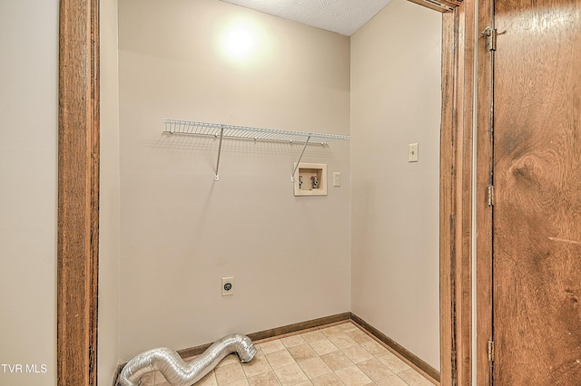 washroom with electric dryer hookup, hookup for a washing machine, and baseboards