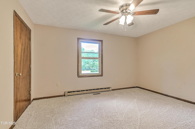 spare room with baseboard heating, carpet floors, a textured ceiling, ceiling fan, and baseboards