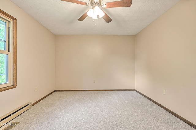 empty room featuring a baseboard heating unit, light carpet, ceiling fan, baseboards, and a textured ceiling