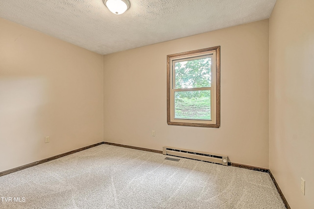 carpeted spare room featuring baseboard heating, baseboards, and a textured ceiling
