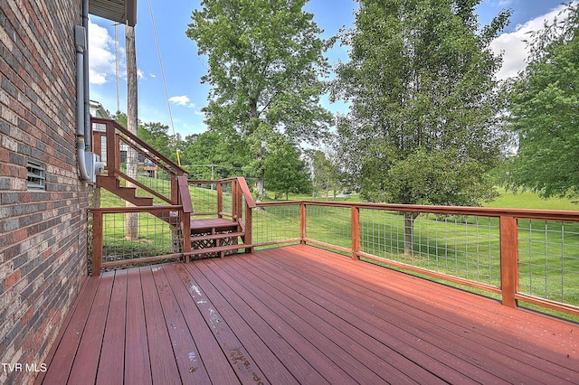 deck with a yard and stairs