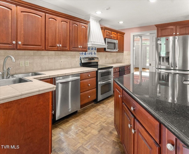 121 Queensgate, Bristol, TN 37620 - kitchen featuring stainless steel appliances, decorative backsplash, recessed lighting, ornamental molding, and brown cabinets
