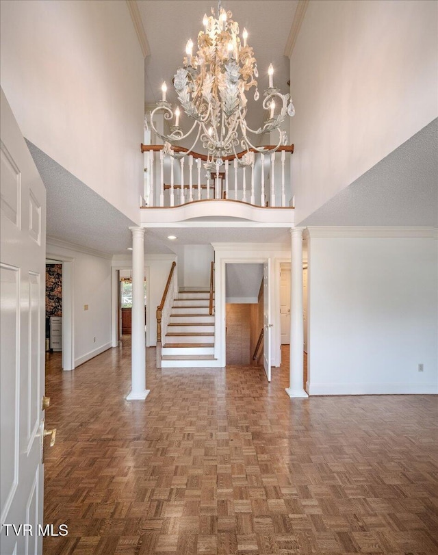 121 Queensgate, Bristol, TN 37620 - entryway with a high ceiling, decorative columns, stairway, ornamental molding, and a chandelier