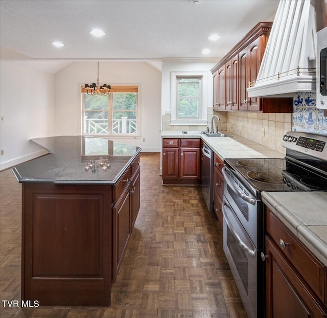121 Queensgate, Bristol, TN 37620 - kitchen with stainless steel appliances, premium range hood, backsplash, recessed lighting, and a chandelier