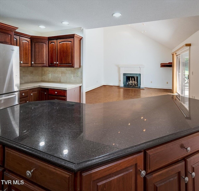 121 Queensgate, Bristol, TN 37620 - kitchen featuring freestanding refrigerator, a kitchen island, tasteful backsplash, a fireplace with flush hearth, and open floor plan