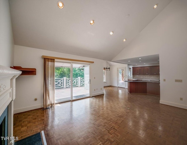 121 Queensgate, Bristol, TN 37620 - unfurnished living room featuring a fireplace, high vaulted ceiling, recessed lighting, and a chandelier