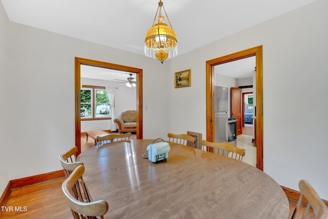 8836 Bristol Hwy, Hiltons, VA 24258 - dining space with a chandelier, a ceiling fan, baseboards, and light wood-style flooring