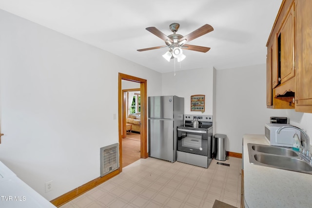 8836 Bristol Hwy, Hiltons, VA 24258 - kitchen with appliances with stainless steel finishes, a sink, a ceiling fan, light floors, and light countertops